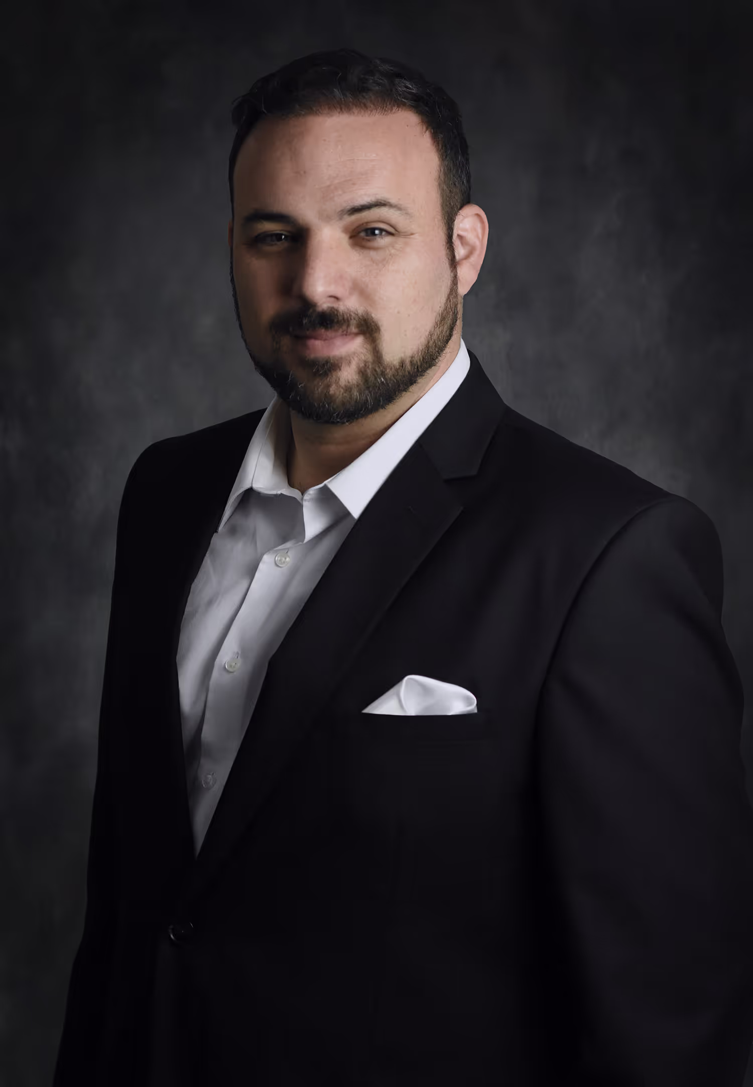 Dr Jon Dabach in a black suit.