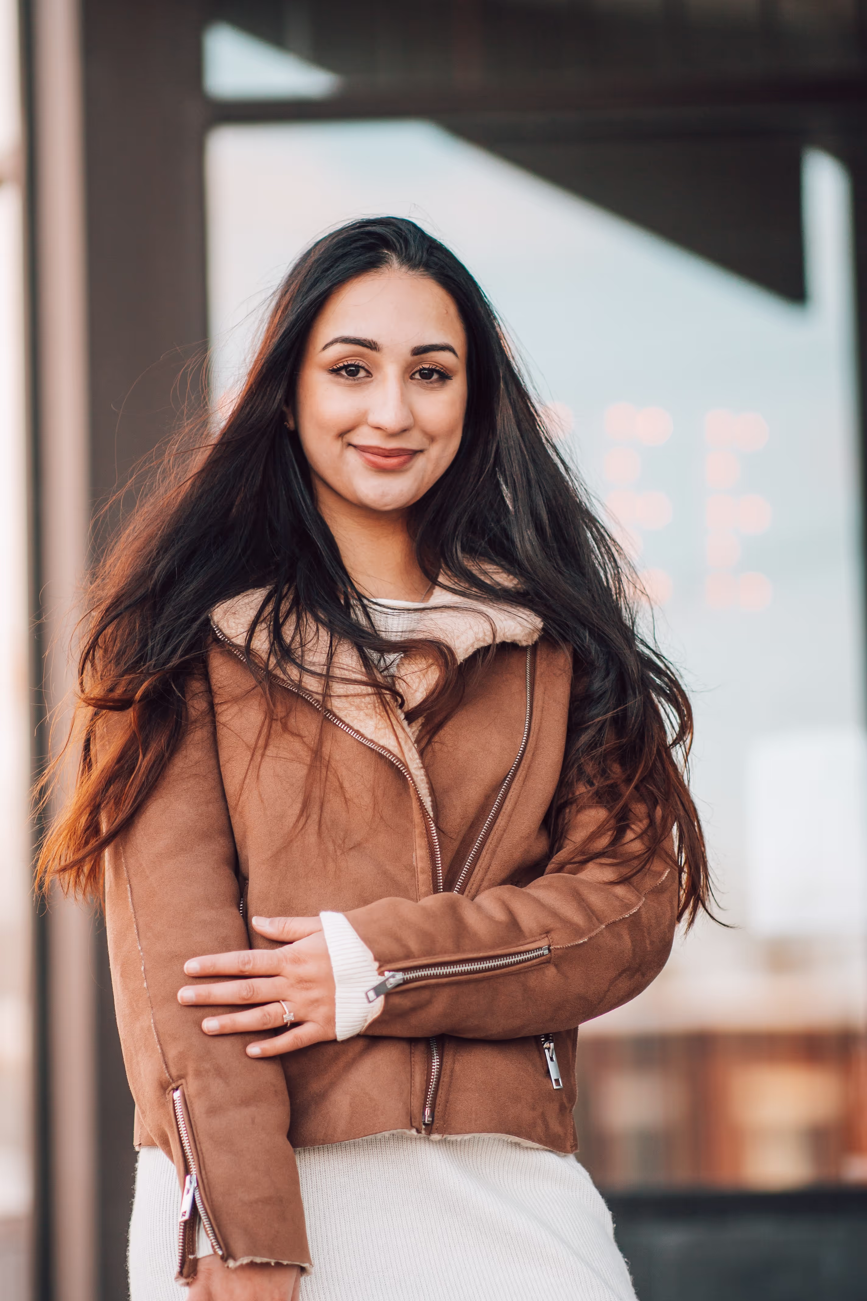 A happy girl in sweater smiling.